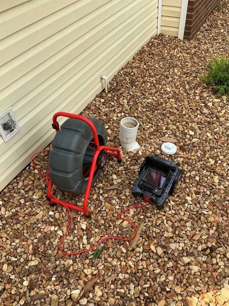Sewer camera reel and monitor at an outside cleanout