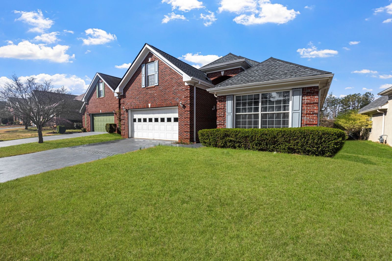 Brick ranch home on a green lawn
