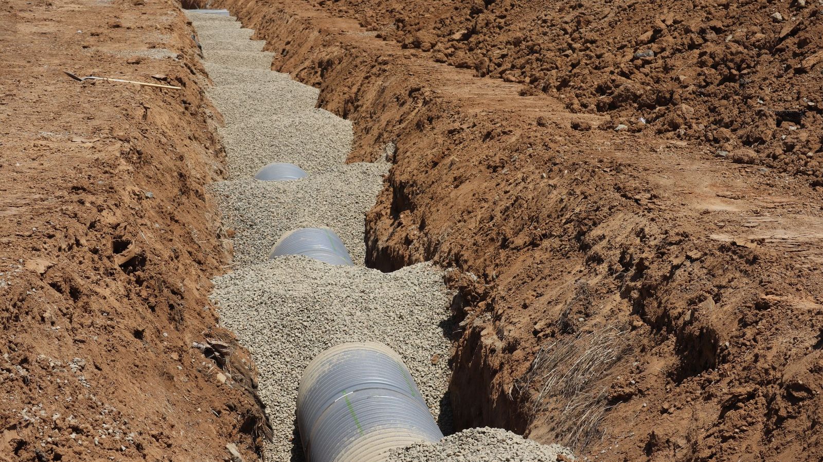 New pipe bedded in gravel in an open trench